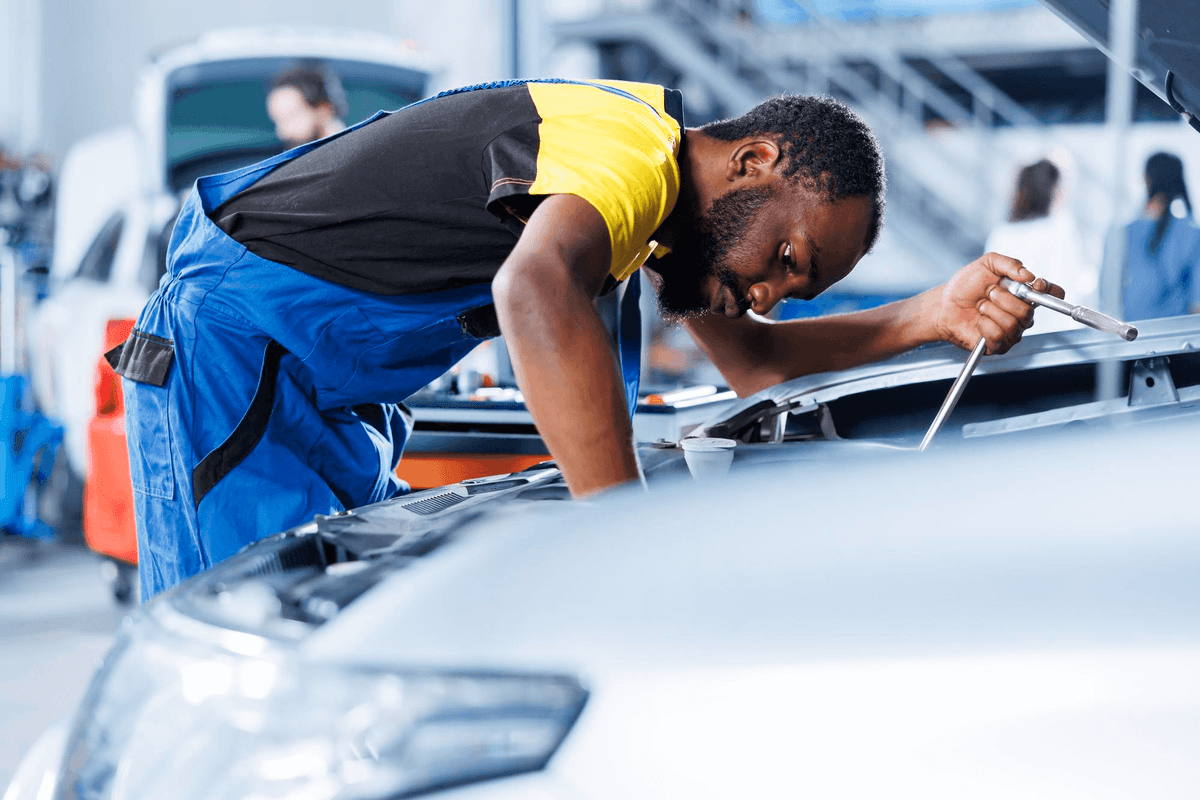 A mechanic working on a car