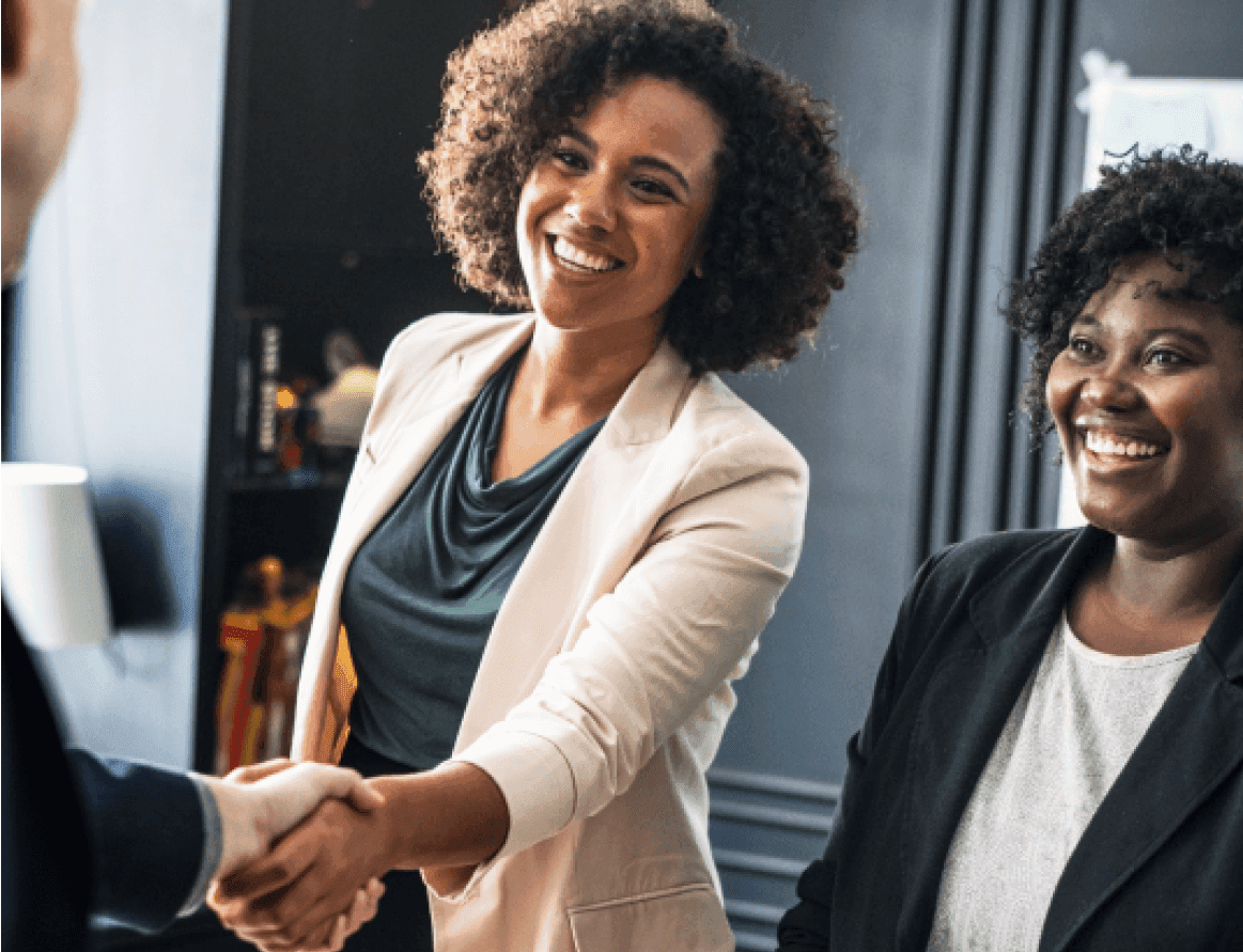 A smiling woman shaking a hand